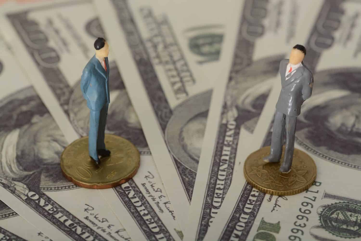 The businessman, standing atop a mound of money coins, locked eyes with his rival, both men engaged in a tense standoff