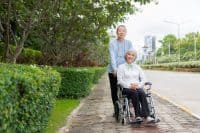Senior Asian couple playing and teasing each other Happy family concept together outside the house Enjoy a fun lifestyle during retirement. Family health care