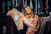 Happy Woman Holding a Matchy Floral Print Blazer. Cheerful fashionista finding an outfit that matches