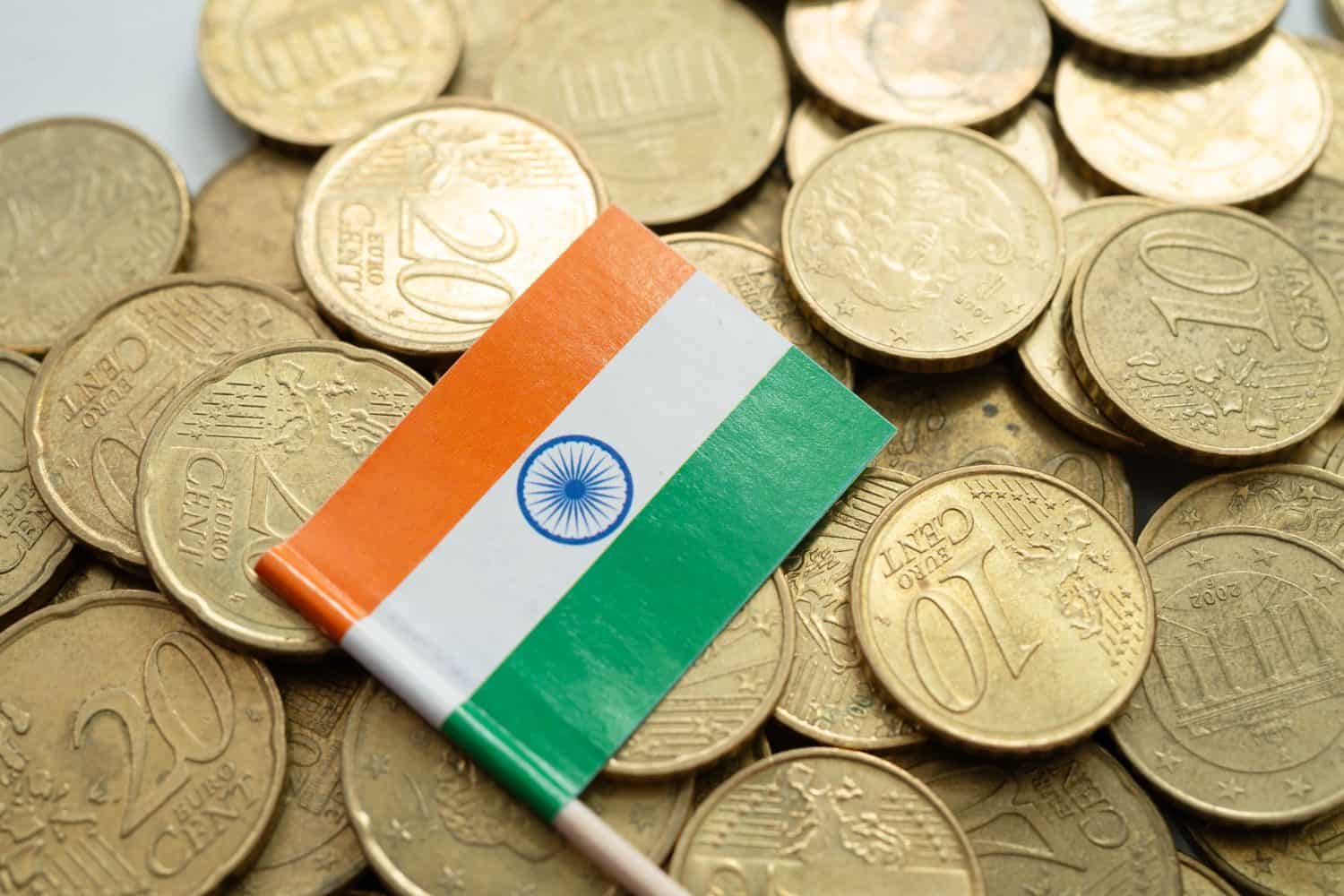 India flag on coins background, finance and accounting, banking concept.