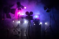 Action movie concept. Police cars and miniature movie set on dark toned background with fog. Police car chasing a car at night. Scene of crime accident. Selective focus