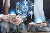 Two business professionals, one holding a smartphone and the other a tablet, are depicted against a backdrop of a blurred city skyline. Overlaying the scene is a blue and white digital network graphic, with a central Ripple logo surrounded by icons representing money, growth, partnership, business, and community, all connected by glowing lines emanating from the mobile devices. The image has a futuristic and interconnected business theme.