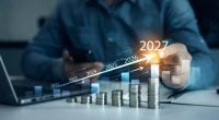 Financial growth data or investment market profit bar and success report 2026.Money business financial graph diagram of coin. Saving money concept.Stack coins with trading price graph growth in 2027.