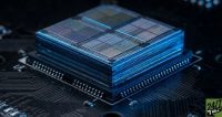 A macro shot of a multi-layered computer processor showing four distinct quadrants of circuitry on a dark circuit board.