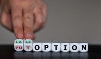 Hand turns dice and changes the expression 'put option' to 'call option'.