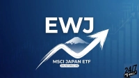A graphic with the letters 'EWJ' in large white font. Below, a white stylized image of Mount Fuji is depicted, with a thick white brush-stroke arrow curving upwards and over it. Underneath the arrow, the text reads 'MSCI JAPAN ETF' and '29% RETURN (1 YR)'. The background is a blue gradient with faint financial bar charts and lines, suggesting growth. A '24/7 WALL ST' logo is visible in the bottom right corner.