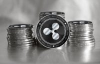 Ripple (XRP) digital crypto currency. Stack of black and silver coins. Cyber money.