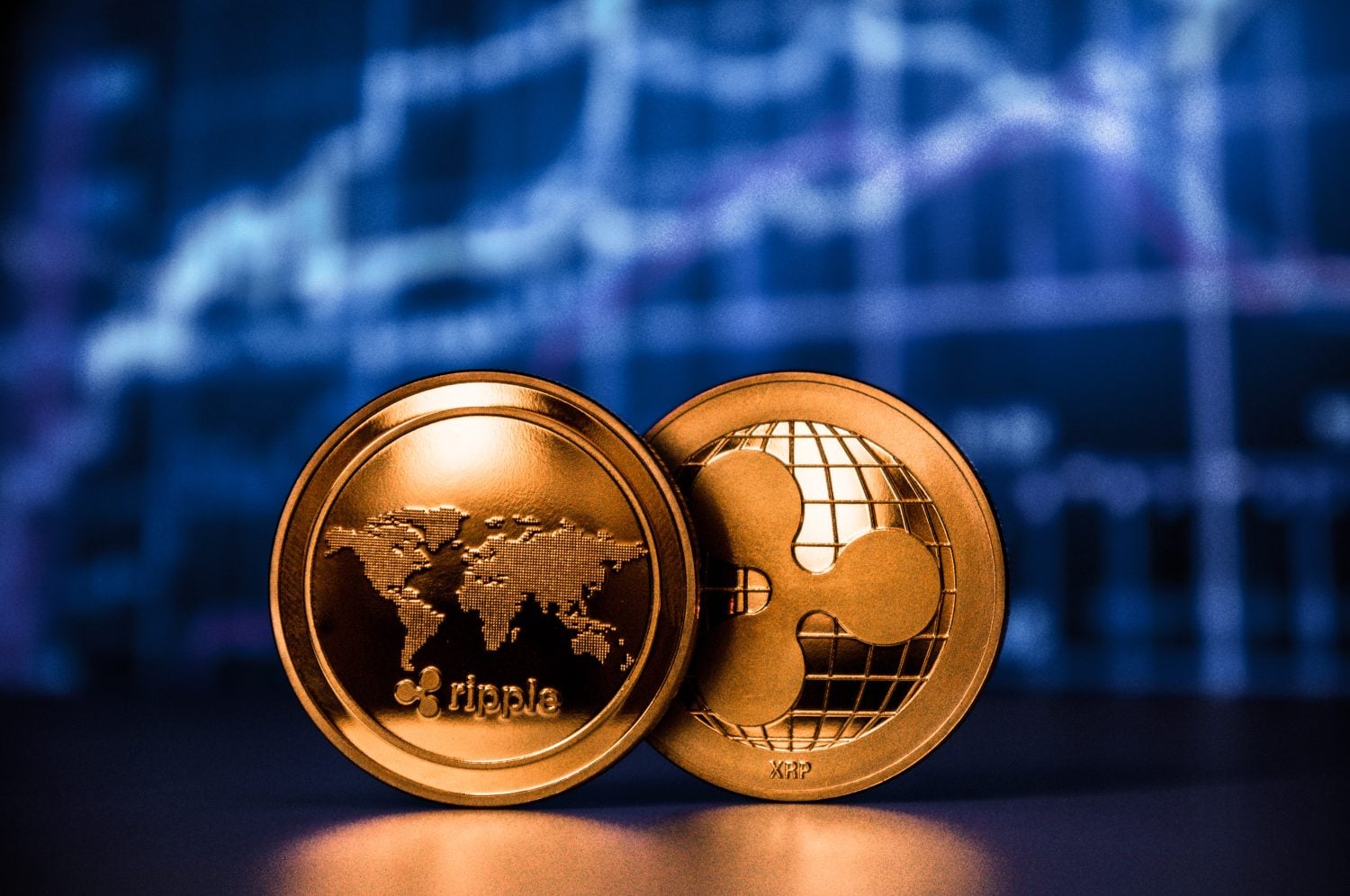 Two ripple coins with chart background