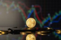 Ripple coin and virtual money concept. Gold Ripple on a stack of coins with chart of growing and falling valuance of a cryptocurrency. Mining or blockchain technology.