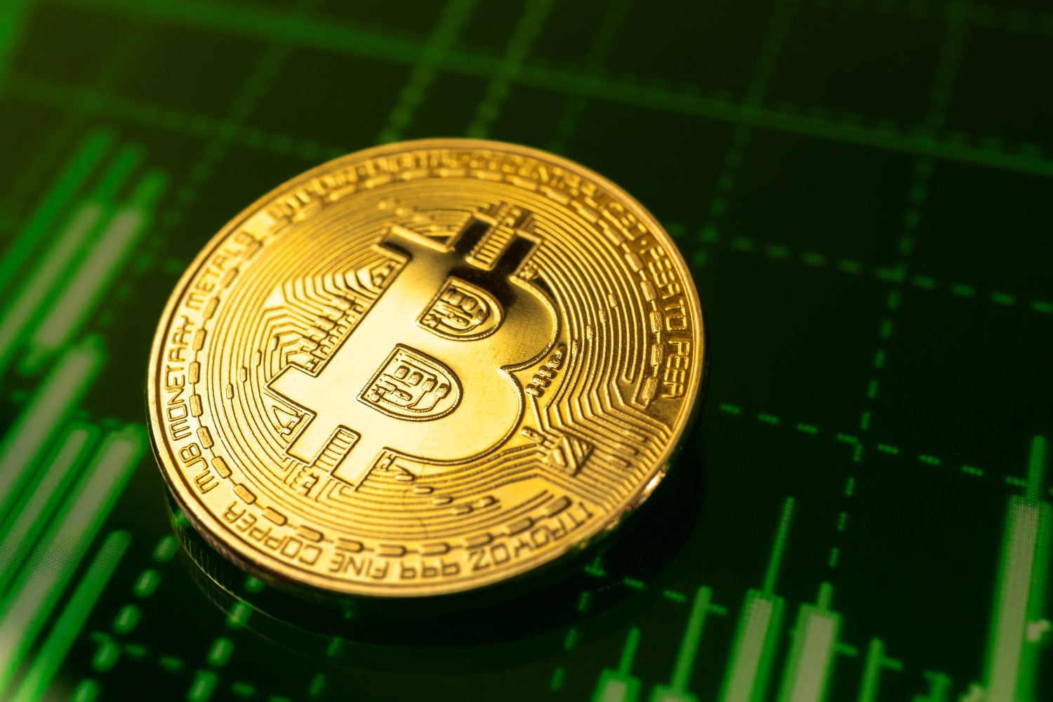 Golden bitcoin coin on green stock chart graphs cryptography background