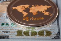 Ripple coin, XRP token, cryptocurrency on US 100 dollar background for design purpose