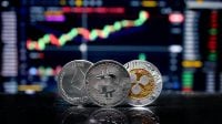 Coin Bitcoin, ETH and XRP on background cryptocurrency trading chart on computer screen. Digital money, banking, investment, finance and business concept.