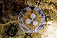 Ripple XRP coin on bitcoins background, cryptocurrency investing concept.