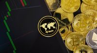 Wide image of Ripple on digital tablet with graph by various coins