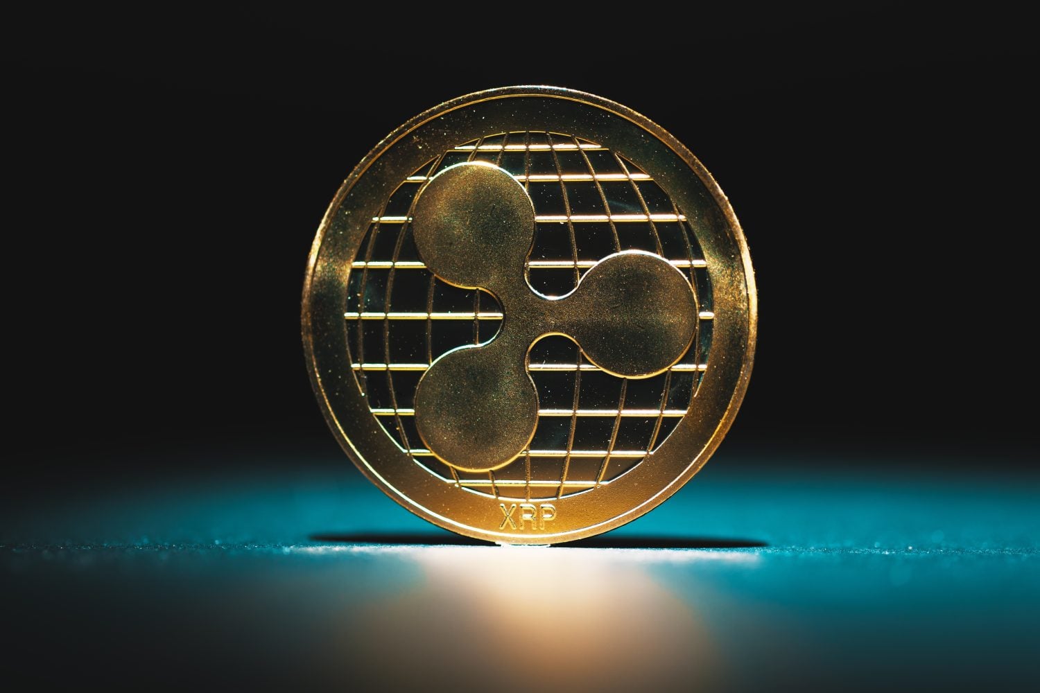 Cryptocurrencies and technology.XRP Ripple gold coins on futuristic and abstract stock charts background. Finance and investment concept.