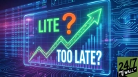 A glowing blue and green digital graphic displays a financial chart. A prominent green line with a large upward-pointing arrow indicates strong growth, accompanied by blue and purple bar charts. Large green text reads 'LITE', followed by a large orange question mark, and then large white text reads 'TOO LATE?'. In the background, blurred financial data tables and blue circuit board patterns are visible. The '24/7 WALL ST' logo is present in the bottom right corner.