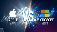 A graphic depicting a split screen, with Apple's white logo and 'APPLE AAPL' text on a dark blue background with glowing financial charts and upward arrows on the left. On the right, Microsoft's colorful four-square logo and 'MICROSOFT MSFT' text are on a dark purple background, also featuring glowing financial charts and upward arrows. A large, glowing gold and white 'VS.' with lightning bolts separates the two sides, emphasizing the comparison. The bottom left features a '24/7 WALL ST' logo.