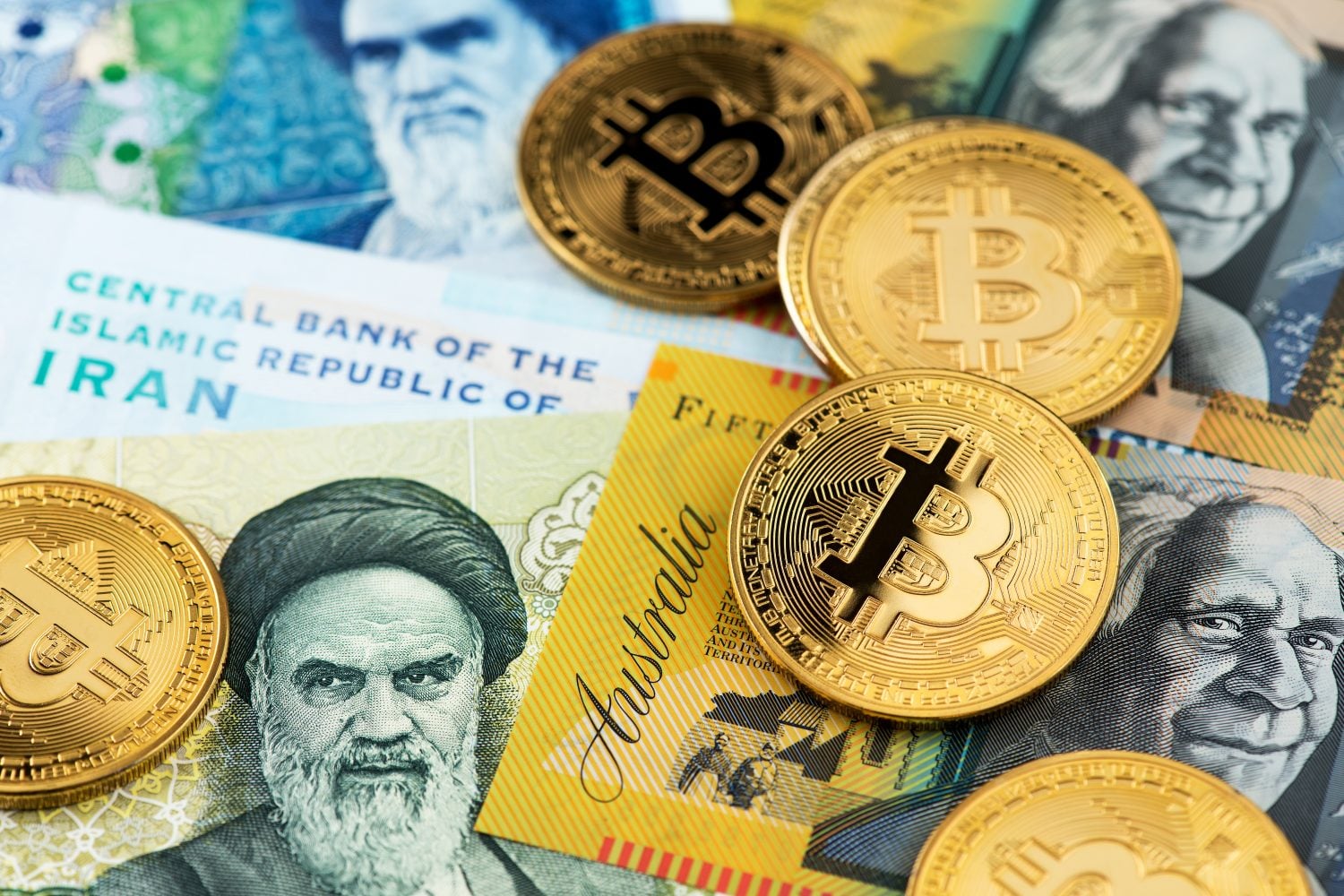 Bitcoin Cryptocurrency BTC coins on Australian Dollar and Iran Rial currency banknotes. Bitcoin Iran Australia BTC IRR AUD Bitcoin Dollar