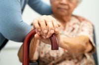 Caregiver help Asian elderly woman patient with love, care, encourage and empathy at nursing hospital, healthy strong medical concept.