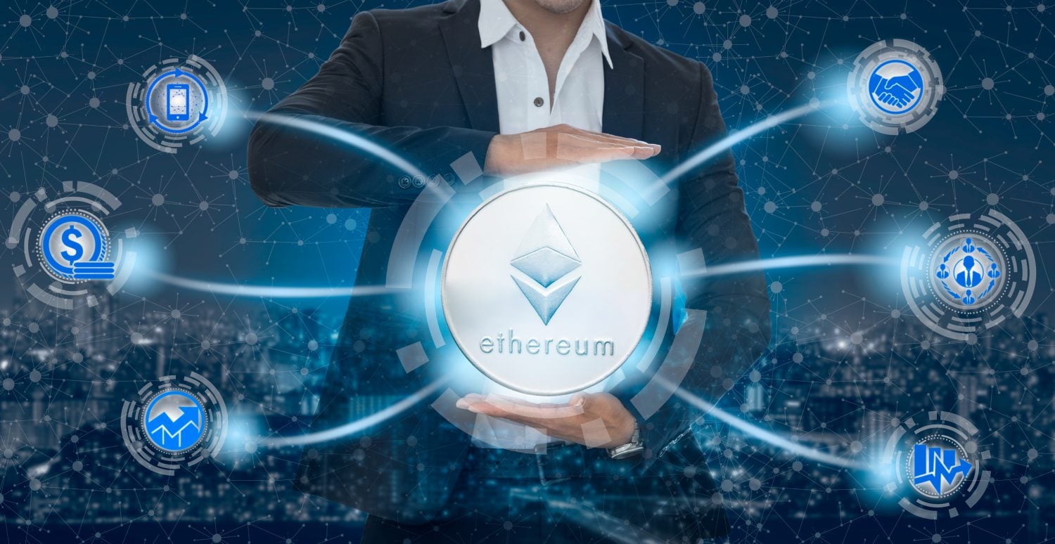 Ethereum and cryptocurrency investing concept - Businessman holding Ethereum (ETH) with mobile application business icons showing exchanging, trading, transfer and investment of blockchain technology.