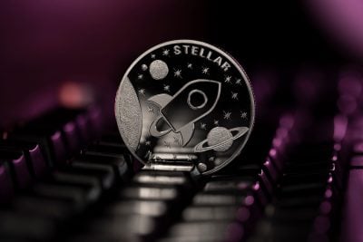 Stellar XLM Cryptocurrency physical coin placed on computer keyboard and lit with purple light.