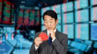 Stock market concept with man holding wallet and thinking