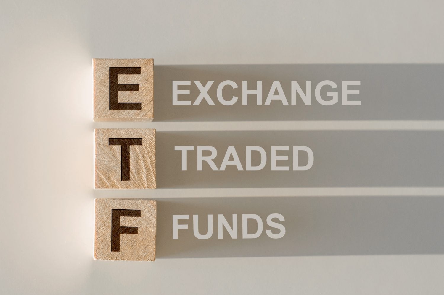 ETF - Exchange Traded Fund text on wooden cubes, on white background