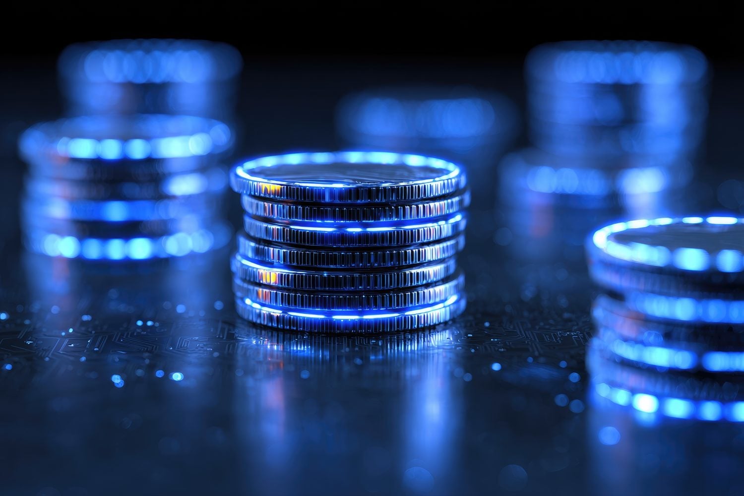 Close-up of stacked coins with a futuristic blue neon glow, symbolizing digital currency, finance, and the future of technology.