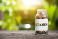 EDUCATION word with coin in glass jar, Business Concept.