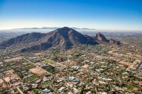 Aerial view above Paradise Valley, Arizona looking SW at Camelback Mountain on a cool December morning 2022