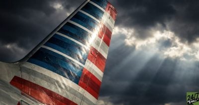 By focusing on the iconic tail fin logo in an extreme close-up with dramatic lighting, we strip away distractions and force the viewer to confront the brand directly. The 'God rays' through storm clouds serve as a metaphor for financial pressure without being literal.