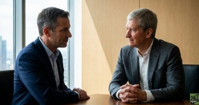 A candid-style interaction between Cook and Ternus provides an 'insider' feel, suggesting a seamless and authoritative hand-off that reassures investors of the company's future.