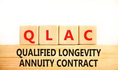 QLAC symbol. Concept word QLAC Qualified Longevity Annuity Contract on beautiful wooden blocks. Beautiful white background. Business QLAC Qualified Longevity Annuity Contract concept. Copy space.