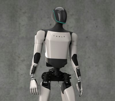 A sleek, modern white and black humanoid robot, the Tesla Bot, is shown from the chest up against a textured gray wall. The robot has a glossy black head with a thin, glowing teal line outlining the face area, resembling an inverted U. Its torso is primarily white with 'TESLA' written in black letters across the chest, and its arms are white with black joint accents. The exposed lower torso reveals dark mechanical components. The robot is looking slightly to its right.
