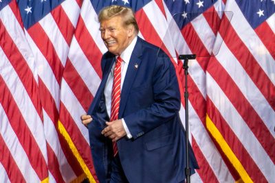 Donald Trump in Front of American Flags at Rally