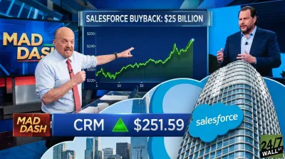 Jim Cramer, wearing a blue shirt and red tie, points with his right hand to a large screen displaying a green line graph showing an upward trend for 'SALESFORCE BUYBACK: $25 BILLION.' To his right, Marc Benioff is shown in a dark suit, speaking. A Salesforce skyscraper and cloud logo are prominently featured, with a blue overlay showing 'CRM ▲ $251.59' and 'MAD DASH' text. The '24/7 WALL ST' logo is in the bottom right.