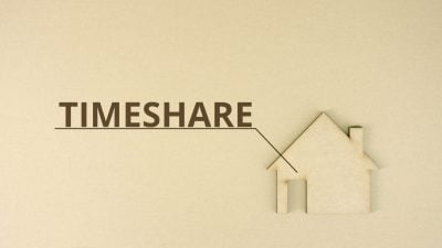 Cardboard home icon with TIMESHARE text on the table