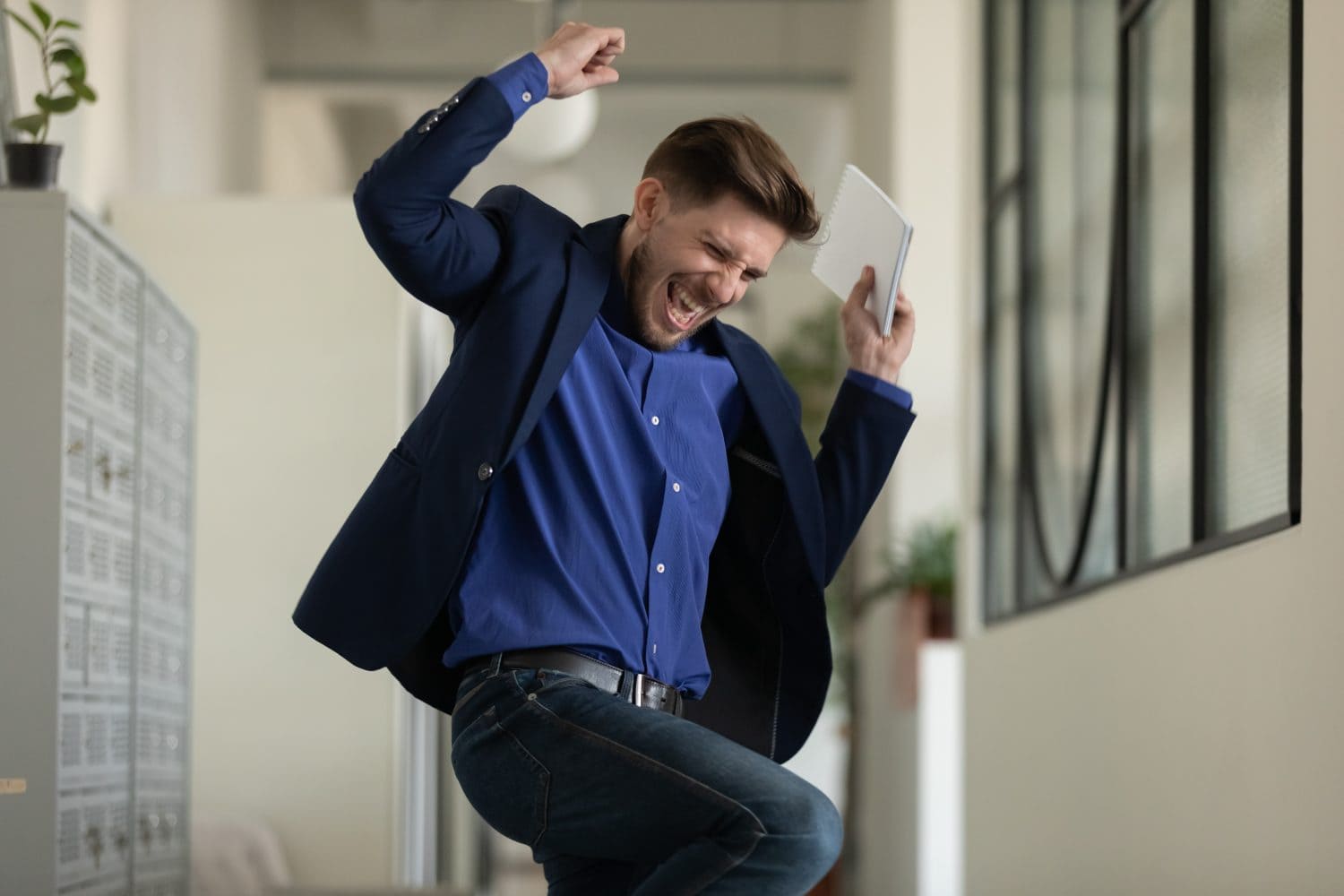 Wish come true. Euphoric happy male executive employee manager worker jumping dancing at office hallway screaming in delight getting career salary growth, finding hard solution, receiving job of dream