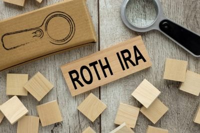 ROTH IRA wooden block on a light table. magnifier and wooden cubes.