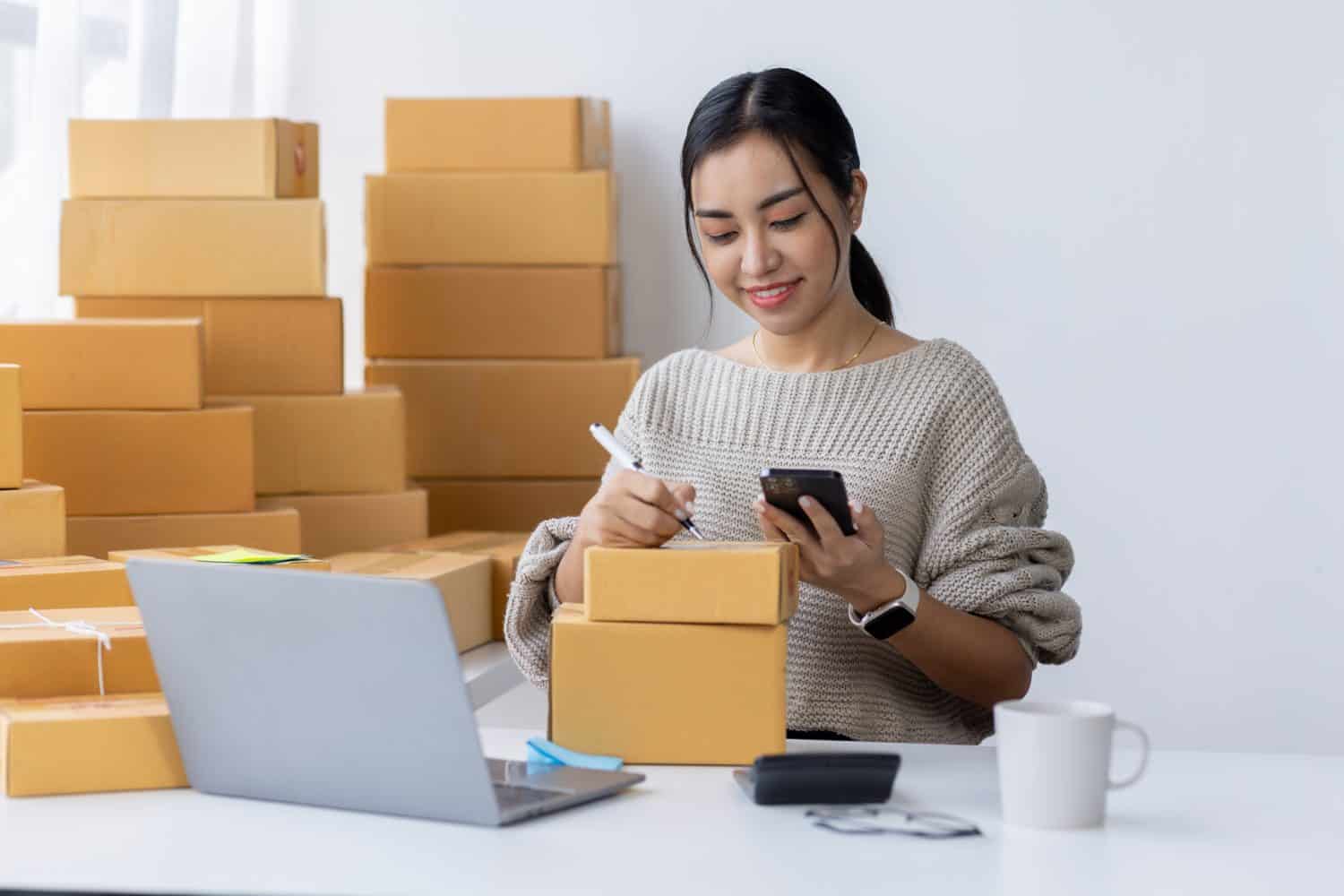 Startup small business entrepreneur SME, asian woman receive order on phone. Success young Asian small business owner home office, online sell marketing delivery, SME e-commerce telemarketing concept