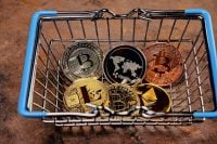 a consumer basket at the bottom of which there are coins of electronic cryptocurrencies Bitcoin, Ethereum, Litecoin, Ripple, as a concept for optat on the Internet