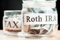 glass jar used for saving US dollar bills and notes for IRA retirement fund