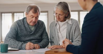 Signature, paperwork and senior couple with financial advisor for retirement annuity saving account. Discussion, finance documents and elderly man and woman with investment banker for pension growth.