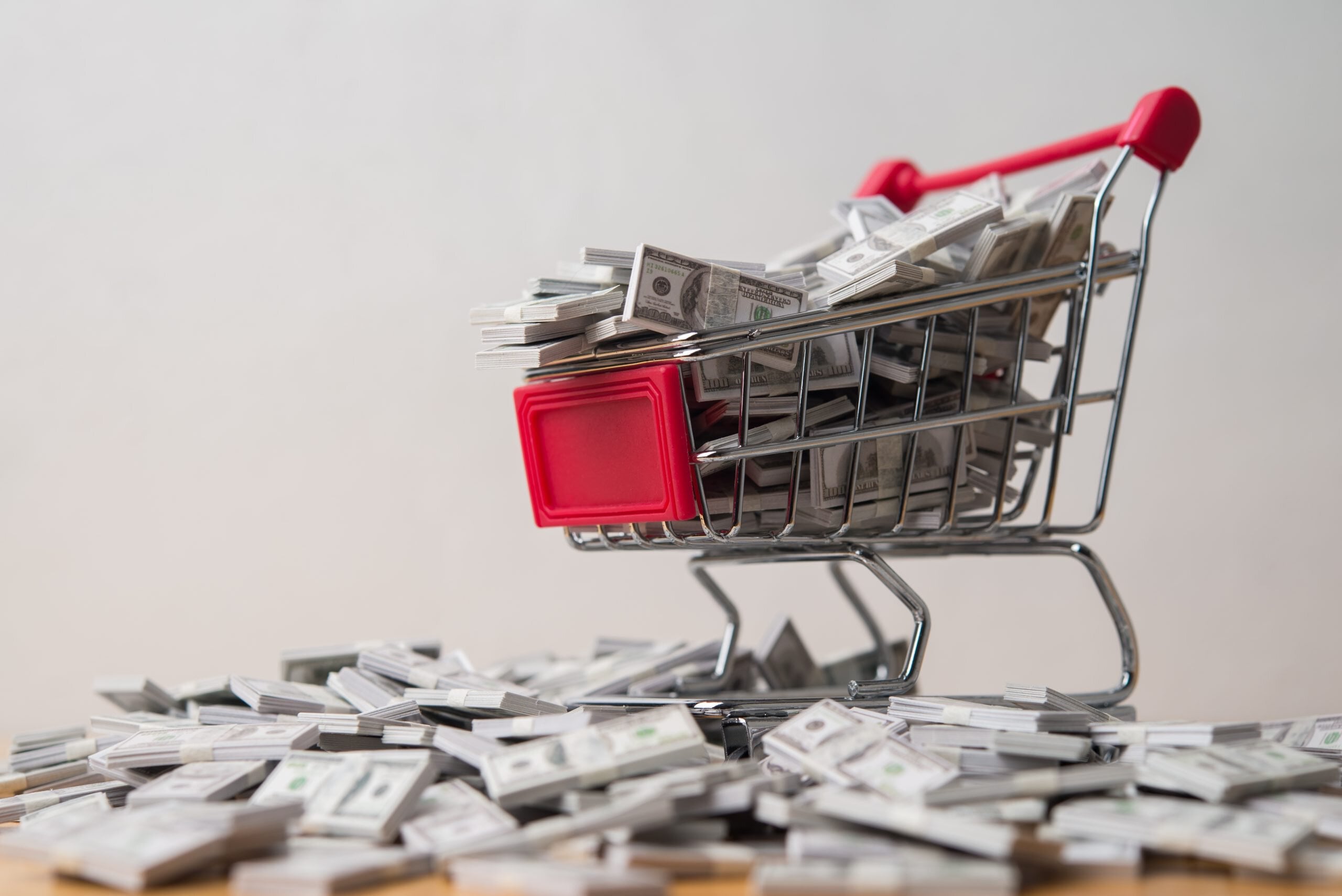 A lot of US dollar banknote with trolley. Return on investment (ETF, stock market, bond, fund, commodity trading, etc.), profit growth from business or investment, wealth, rich, passive income concept