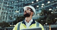 Tablet, engineer thinking and man in city for construction, planning and low angle at dawn. Technology, building and architect outdoor for maintenance decision, safety inspection or problem solving