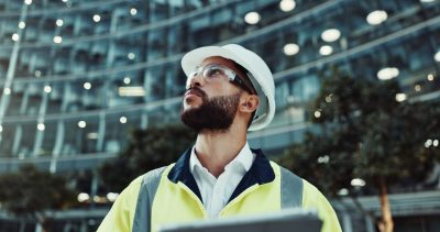 Tablet, engineer thinking and man in city for construction, planning and low angle at dawn. Technology, building and architect outdoor for maintenance decision, safety inspection or problem solving