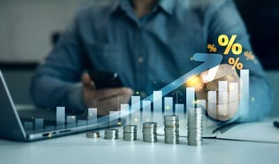 Person is calculating income and return in percent.Percentage interest rates continue to increase, stocks and mutual funds, compensation fund, investment,retirement and dividend tax graph.