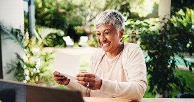 Letter, senior or excited woman with receipts for tax return, deduction or savings in home. Celebrate, mature person and success with smile for financial freedom, retirement or pension fund at house