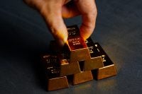 Man's hands arranging gold bars,Finance and  Investment.