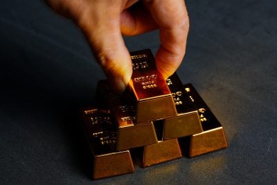 Man's hands arranging gold bars,Finance and  Investment.
